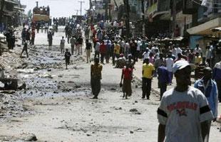 People walk across an area where shops were destroyed after days of post-election riots in Nairobi January 2, 2008. REUTERS/Thomas Mukoya 