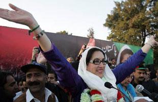 Former Pakistani Prime Minister Benazir Bhutto waves to her supporters at Liaquat Bagh in Rawalpindi, Pakistan, Dec. 27, 2007. Bhutto died Thursday as Party security adviser says she was shot in the neck and chest as she got into her vehicle, then gunman blew himself up. At least 20 others were also killed in a blast that took place as Bhutto left the rally. (Xinhua/AFP Photo)