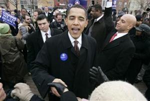 Democratic presidential candidate Senator Barack Obama (D-IL) greets supporters and commuters in Southeast Washington, February 12, 2008. (Jim Bourg/Reuters)