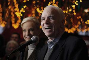 Republican presidential candidate U.S. Senator John McCain (R-AZ) (R), speaks to reporters as his wife, Cindy, looks on at Mi Tierra Restaurant in San Antonio, Texas March 4,2008. (Xinhua/Reuters Photo)