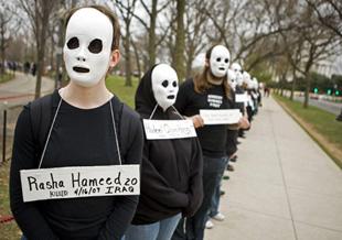 Anti-war protesters wear white masks and placards with the names of Americans and Iraqis killed during the war in Iraq during a demonstration near the Vietnam Memorial in Washington March 19, 2008. Wednesday marked the fifth anniversary of the US-led invasion in Iraq. [Agencies]