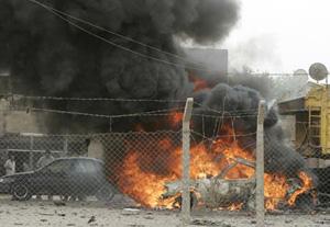 Vehicles burn after a U.S. air strike in a parking lot in Baghdad's Sadr City March 28, 2008.(Xinhua/Reuters Photo)