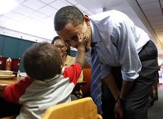 U.S. Democratic presidential candidate Senator Barack Obama (D-IL) has his cheek touched by 7-month-old Aedyn Buchanan as he visits diners at Stephanie's II homestyle restaurant in Greensboro, North Carolina, May 5, 2008.(Xinhua/Reuters Photo)