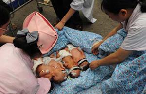 Newly born babies are moved to open space to avoid danger in a hospital after an earthquake occurred in Nanchong, a city of southwest China's Sichuan Province on May 12, 2008. A major earthquake measuring 7.8 Richter Scale jolted Wenchuan County of Southwest China's Sichuan Province at 2:28 p.m. on Monday. Earthquake was felt in Nanchong, Chengdu, Chongqing, Zhengzhou and Lanzhou. The International Nurse Day celebrated on the day of May 12.