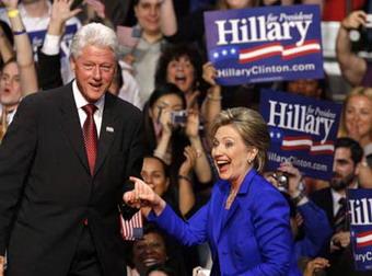 Former President Bill Clinton helps his wife and US Democratic presidential candidate Senator Hillary Clinton to the stage at her South Dakota and Montana presidential primary election night rally in New York June 3, 2008.(Xinhua/Reuters Photo)