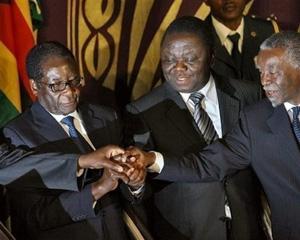 Zimbabwe President Robert Mugabe (left), Prime Minister Morgan Tsvangirai (centre) and former South African leader Thabo Mbeki shake hands after signing a power-sharing accord on September 15.(AFP/File/Desmond Kwande)