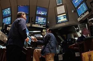 Financial professionals look over computer monitors at their stations on the floor of the New York Stock Exchange near the beginning of the trading day in New York. Global stock markets bounced from valley to peak Friday in choppy trade that saw big gains in Europe but a loss of momentum on Wall Street, with investors frazzled in the face of a looming economic slowdown.(AFP/Getty Images/Chris Hondros)