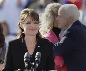 Republican vice presidential candidate Alaska Gov. Sarah Palin waits to speak to the crowd as presidential candidate Sen. John McCain, R-Ariz., hugs his wife Cindy at a rally in Green, Ohio, Wednesday, Oct. 22, 2008.(AP Photo/Amy Sancetta)