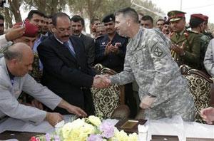 Maj. Gen. Michael Oates, U.S. commander south of Baghdad, right, shakes hands with Salim al-Musilmawi, Babil's provincial governor,during a transfer ceremony held in the city of Hilla, near the ruins of the ancient city of Babylon, on Thursday, Oct. 23, 2008.(AP Photo/Alaa al-Marjani)