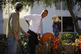 U.S. Democratic presidential candidate Senator Barack Obama pretends his back after picking up a pumpkin at the First United Methodist Church in Sarasota.(Xinhua/AFP Photo)