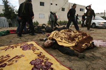 Bodies of Palestinian Hamas policemen are scattered on the ground following an Israeli air strike in Gaza City on December 27, 2008. About 200 Palestinians were killed and hundreds wounded in a series of simultaneous Israeli air strikes in Gaza Strip. (Xinhua/Stringer)