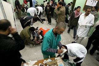 Wounded Palestinians are treated on the floor of Kamal Edwan hospital in Beit Lahia in the northern Gaza Strip following an Israeli air strike on the nearby Jabalia refugee camp. (AFP/Mohammed Abed)