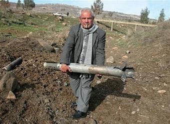 A Lebanese man carries part of a 122 mm rocket which was fired from Lebanon at Israel but missed its target and fell in a field in the southern village of al-Mari, 2 kilometers from the Lebanese-Israeli border. Three rockets fired from Lebanon slammed into northern Israel on Wednesday in an attack that frayed nerves on both sides of the tense border for the second time in less than a week.(AFP/Taher Abou Hamdan)