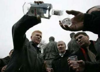 Afghan war veterans toast with vodka as they remember those who were killed in the war during a commemoration of the 20th anniversary of the Soviet troops withdrawal in Kiev, February 15, 2009. The withdrawal of the last Soviet troops from Afghanistan on February 15, 1989 ended a decade of fighting that killed an estimated 15,000 Soviet troops and convinced a generation of soldiers they had been sent to fight a war they could not win.REUTERS/Konstantin Chernichkin (UKRAINE)