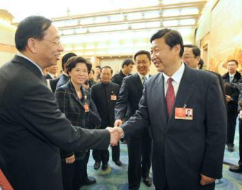 Chinese Vice President Xi Jinping (front R), who is also a member of the Standing Committee of the Political Bureau of the Communist Party of China (CPC) Central Committee, shakes hands with a deputy to the Second Session of the 11th National People's Congress (NPC) from east China's Shanghai Municipality, in Beijing, capital of China, March 5, 2009. Xi Jinping joined in the panel discussion of Shanghai delegation on the opening day of the Second Session of the 11th NPC. (Xinhua/Ma Zhancheng)
