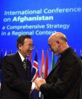 Afghan President Hamid Karzai (R) shakes hands with United Nations Secretary General Ban-Ki-Moon at the start of a U.N.-backed conference on Afghanistan in The Hague March 31, 2009. Karzai told the international conference with delegates from Pakistan and Iran on Tuesday that Afghanistan needed regional cooperation to tackle terrorism.REUTERS/Jerry Lampen  
