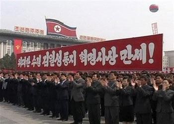 In this photo made off APTN footage, North Koreans attend a mass rally at Kim Il Sung Square in Pyongyang, North Korea, Friday, April 10, 2009 to celebrate the re-election of Kim Jong Il as chairman of the powerful National Defence Commission. The banner reads 'Hurrah for great leader Kim Jong Il's revolutionary idea ! '(AP Photo/APTN) 