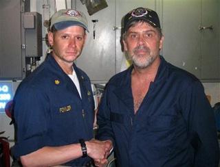 In this photo released by the U.S. Navy, Maersk-Alabama Capt. Richard Phillips, right, shakes hands with Lt. Cmdr. David Fowler, executive officer of USS Bainbridge after being rescued by U.S Naval Forces off the coast of Somalia on Sunday April 12, 2009.(AP Photo/ U.S. Navy)