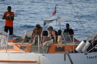 A picture released by the French army off the Somalian coast shows pirates and hostages on the boat, the Tanit, that was seized by Somali pirates on April 4. (AFP/Ecpad)