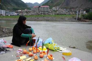 A mother mourns for her child who was only 67 days old when killed in last year's May 12 earthquake in Beichuan, the hardest-hit area in the disaster, in southwest China's Sichuan Province, on May 10, 2009. Parents who lost their children came back to Beichuan as the first anniversary of the disaster approaches. (Xinhua/Jiang Hongjing)