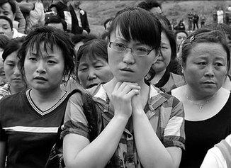 People pay their respect to dead earthquake victims in Beichuan,Sichuan province on Monday, one day before the first anniversary of the disaster which claimed nearly 90,000 lives.[Xu Jingxing] Photos: May 12 quake remembered across China