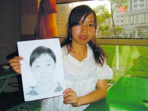 Luo Caixia, whose identity was stolen, shows the photo of her classmate Wang Jiajun who entered a university by using Luo's name many years ago in this undated photo.[Photo: China Youth Daily]