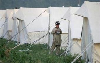 An internally displaced boy, escaping a military offensive in the Swat valley, stands outside his family tent at a UNHCR camp (United Nations High Commission for Refugees) in Mardan district, about 120 km (75 miles) northwest of Pakistan's capital Islamabad, May 12, 2009. REUTERS/Faisal Mahmood